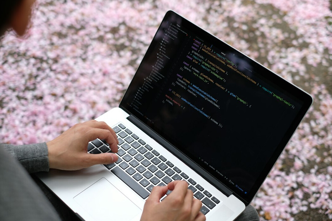 programmer writing secure code on laptop